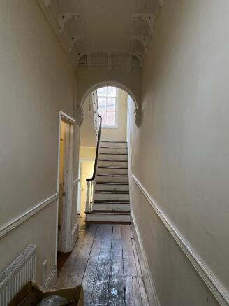 Elegant period hallway with arched details...