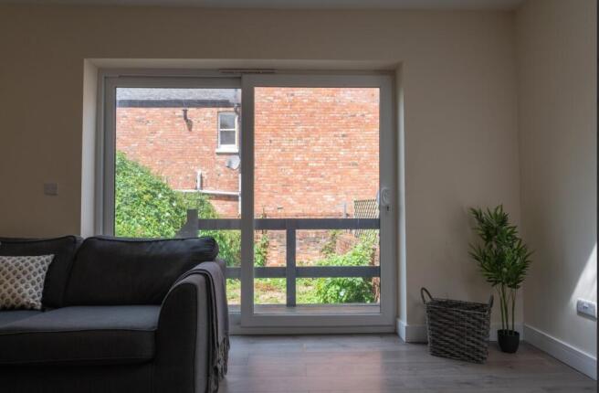Bright and inviting living room featuring large...