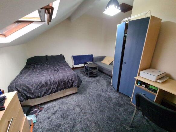 A cozy and well-maintained master bedroom featu...