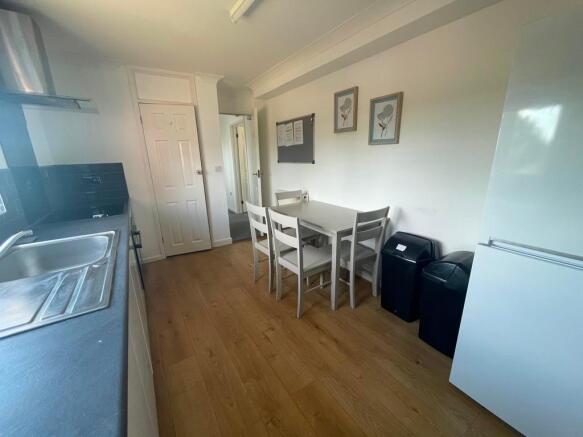 Bright, modern kitchen with a laminate floor, f...