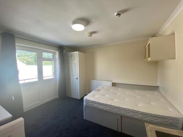Bright bedroom with double bed and ample storag...