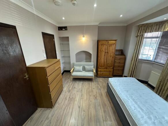 Spacious bedroom with ample storage and seating...