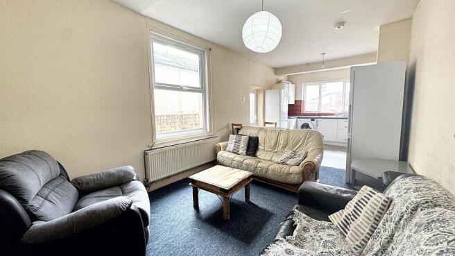 Bright, comfortable living room with a large wi...