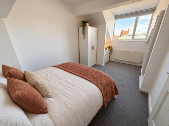 Warmly staged attic bedroom (1).png