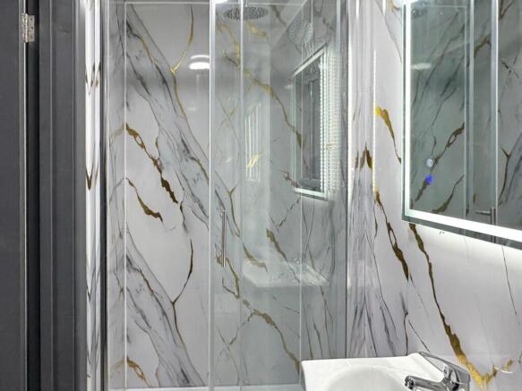 Contemporary bathroom suite featuring a glass-e...