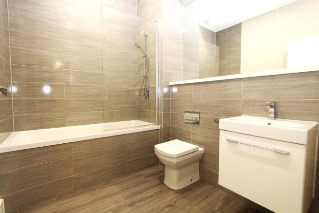 Modern bathroom with sleek tiles and full bath...