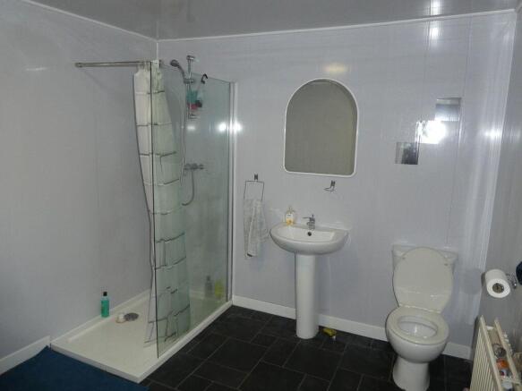 Bright, modern bathroom with a glass-enclosed c...