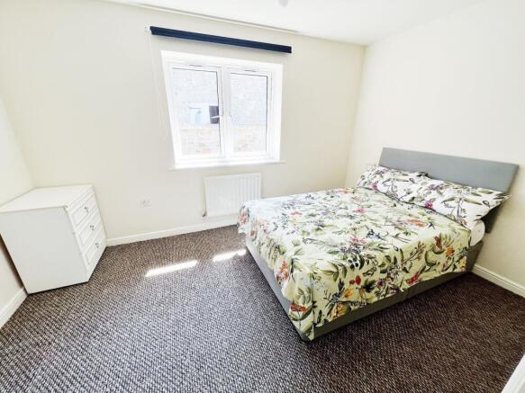 Bright, neatly presented bedroom with a double ...