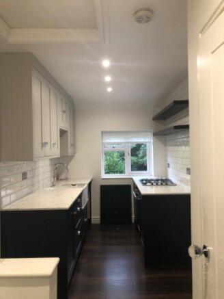 On the left of the stairs is the kitchen with a vi