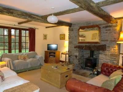 Sitting Room with Stone Fireplace and Wood Burner