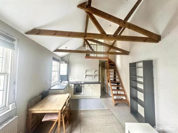 Bright kitchen/diner with exposed beams...