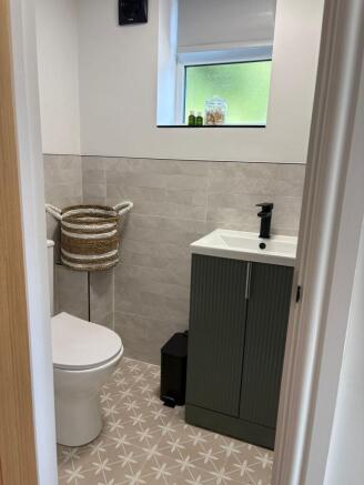 Modern, neatly finished bathroom with patterned...