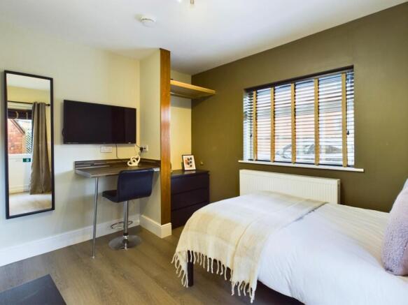 A stylish and well-lit double bedroom featuring...