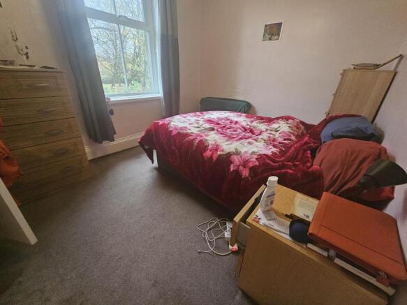 A cozy double bedroom with natural light coming...