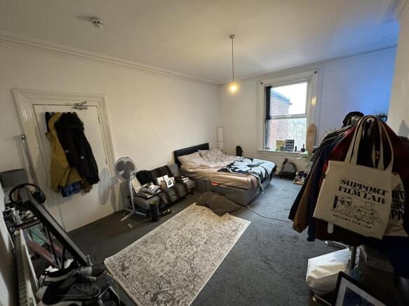 Spacious master bedroom with large window...