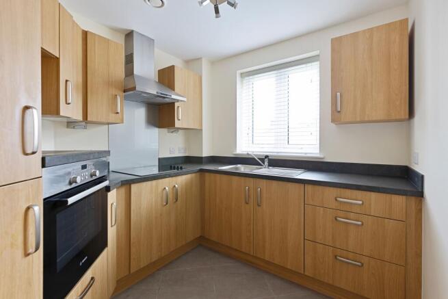 a kitchen with wooden cabinets