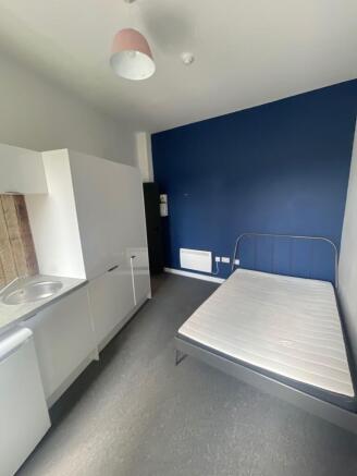 A compact double bedroom featuring a neat metal...