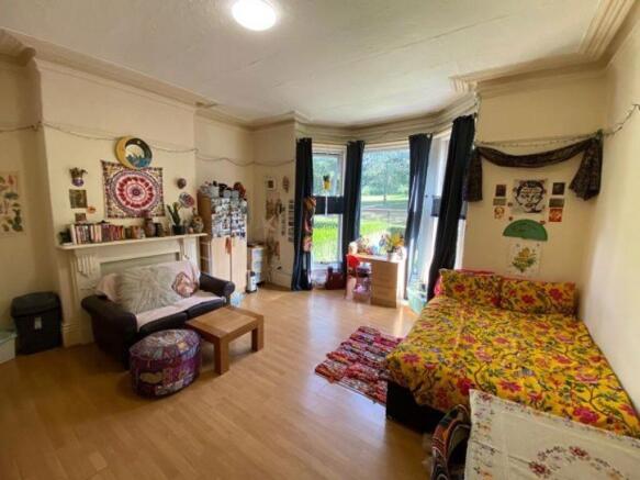 A spacious and cozy master bedroom featuring a ...