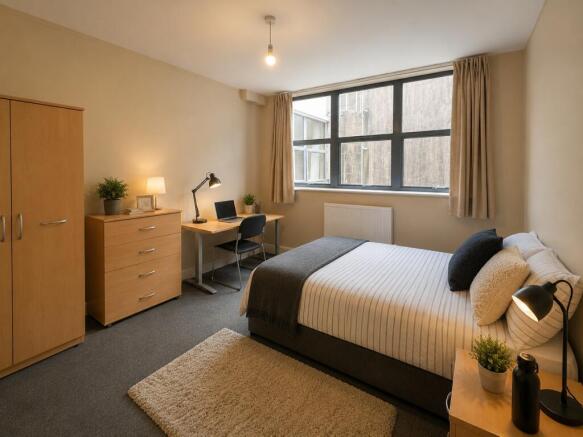 Bright bedroom with double bed and desk area...