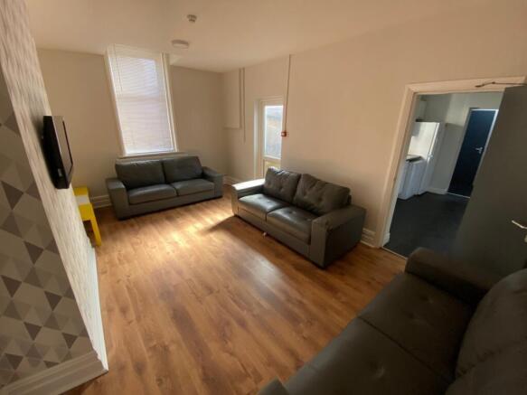 A spacious and inviting modern living room, per...