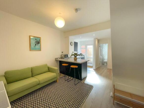 A spacious and modern living room featuring a c...