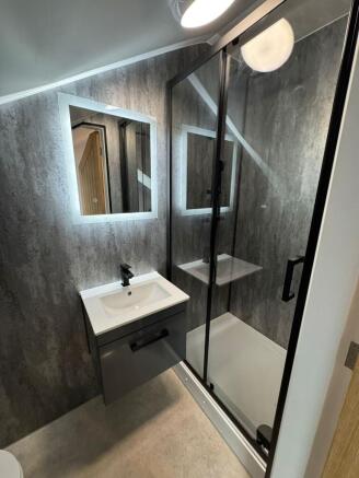 Contemporary ensuite bathroom with a sleek vani...