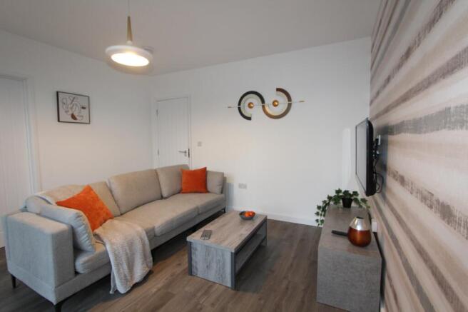 A stylish and contemporary living room featurin...