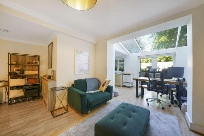 Bright living room with a skylight and large windo
