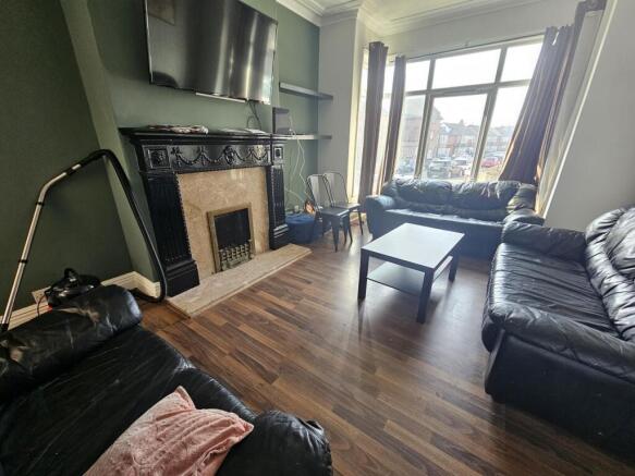 Bright lounge with bay window and fireplace...