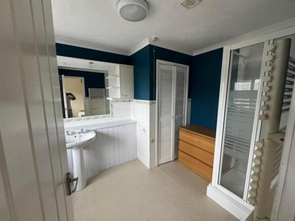 Bright bathroom with shower and storage space...