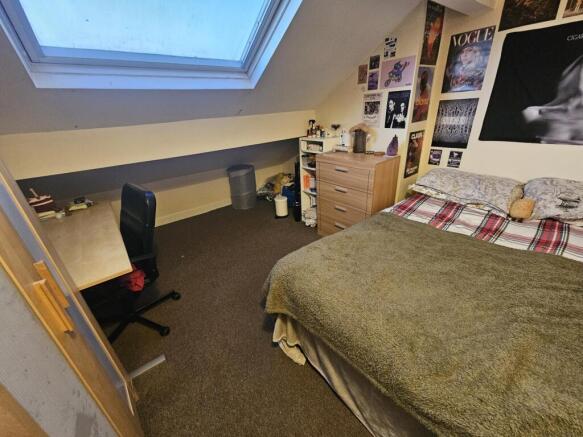 Comfortable attic double bedroom with a skyligh...