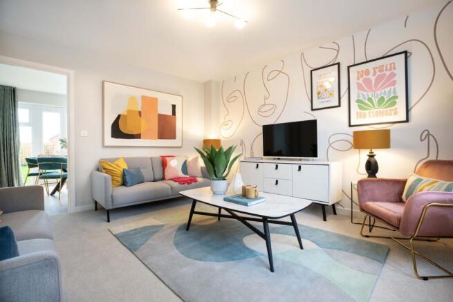A modern living room with a grey sofa and abstract art in the foreground