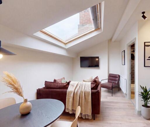 Bright lounge with a large skylight and stylish...