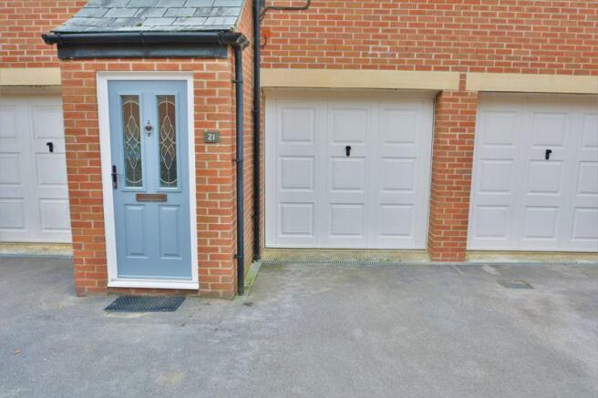 Front door, drive, and garage