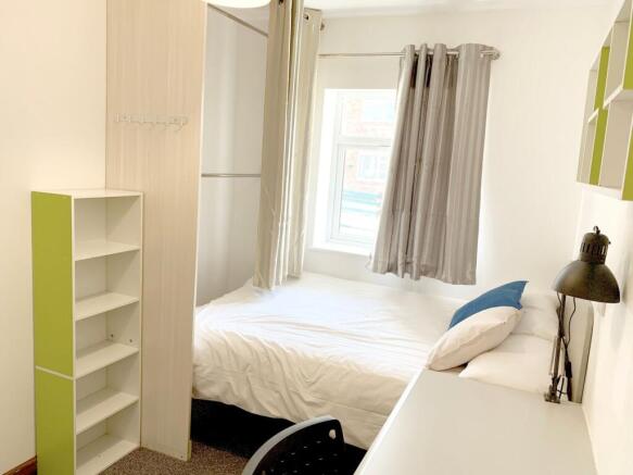 A bright and tidy double bedroom featuring a co...