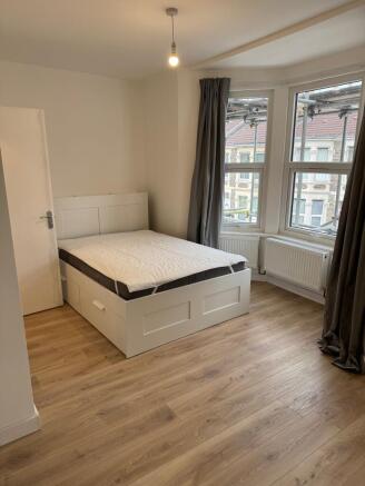 Bright and inviting double bedroom featuring la...