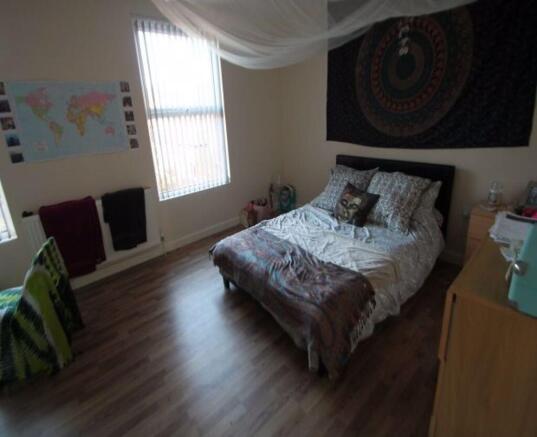 A spacious and inviting bedroom featuring a com...