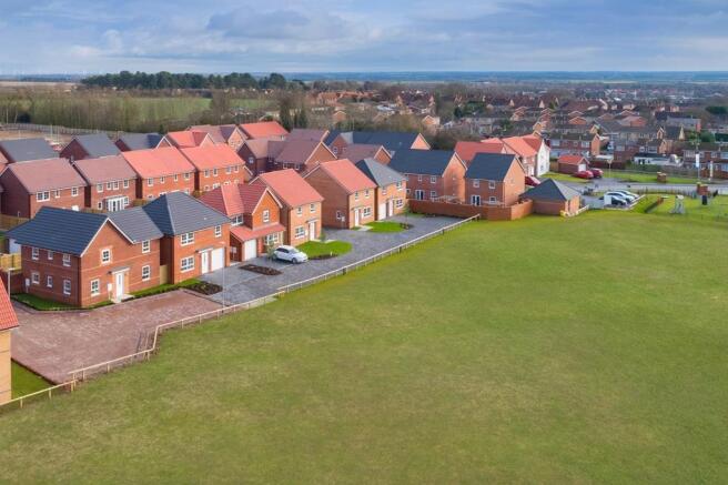 Birds eye view of homes opposite green open space at Mortimer Park