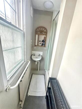 Narrow bathroom with sink and natural light...
