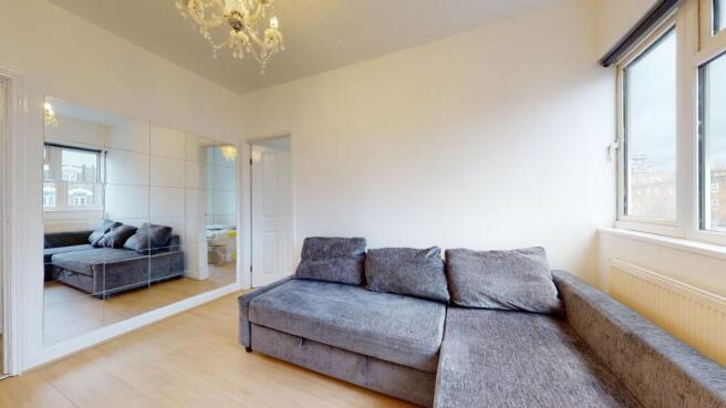 Bright lounge with plush sofa and mirrored wall...