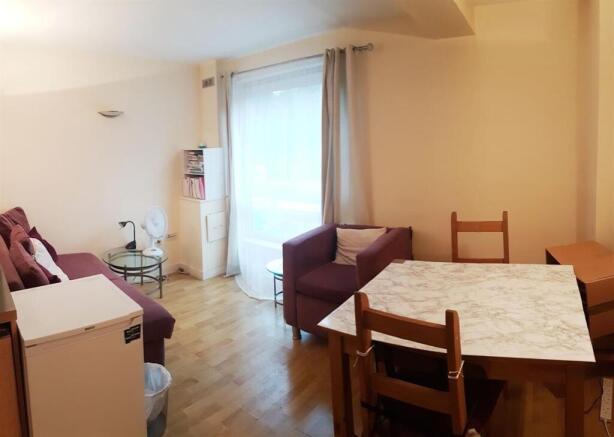 Bright living area with dining table and seatin...