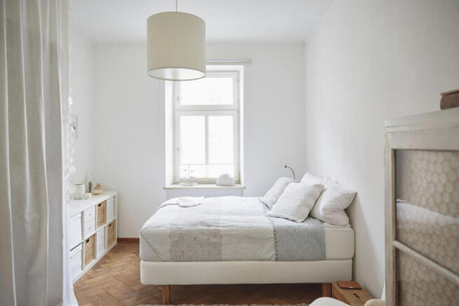 white-coloured-bedroom-with-parquet-floor-bed-and-