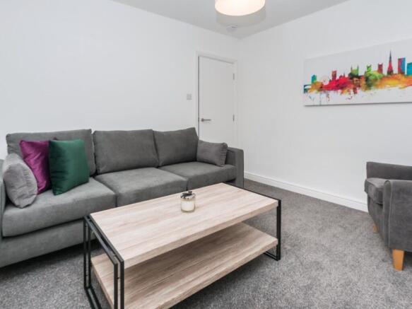 Bright, modern living room with a comfortable g...