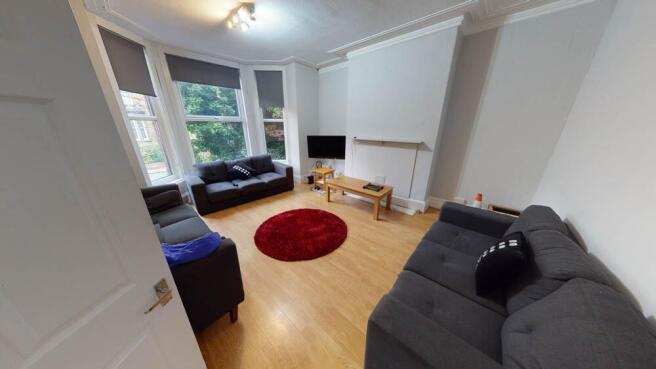 Bright and inviting living room with large wind...