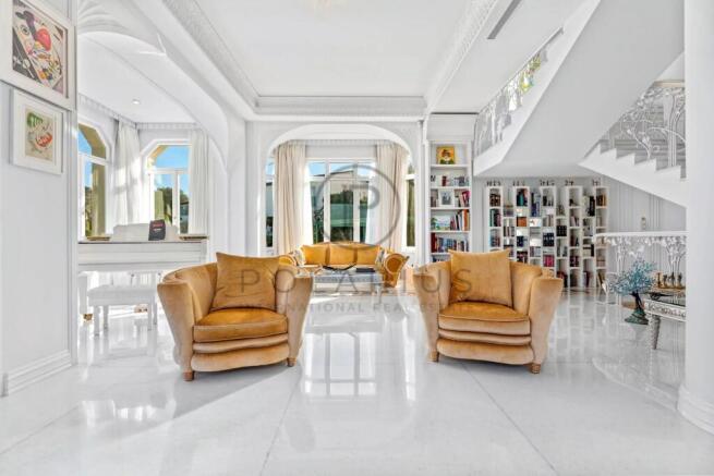 Luxurious, bright living area with plush velvet ch