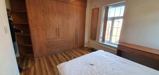 Bright bedroom with large fitted wardrobes, woo...