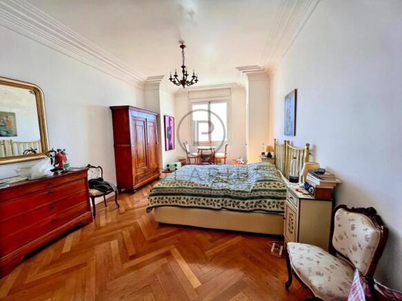 Spacious bedroom with classic furniture and a larg