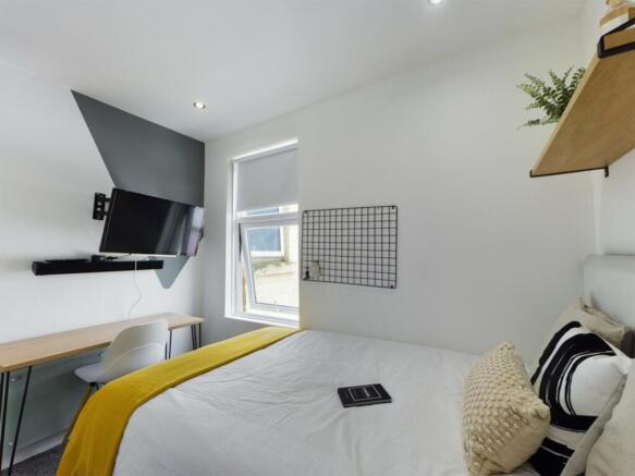 A bright and inviting double bedroom featuring ...
