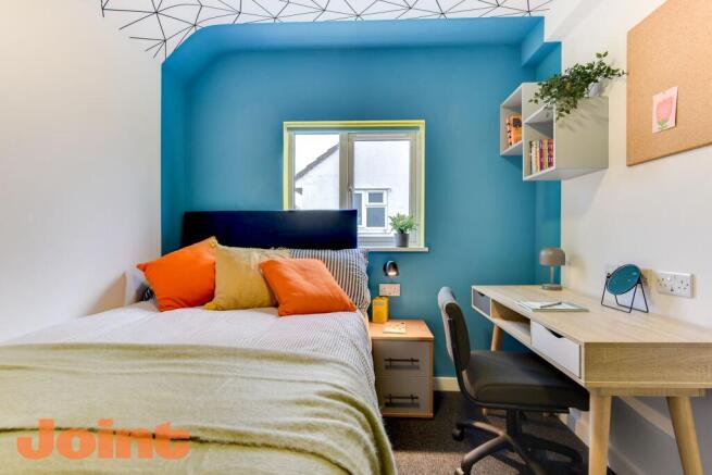 Bright, well-styled bedroom with a double bed d...