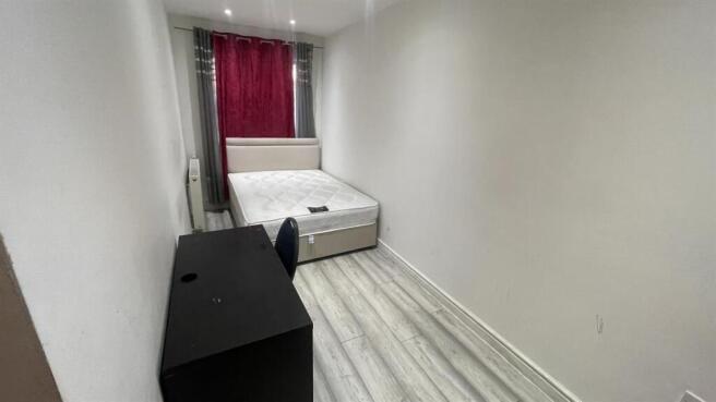 Modern double bedroom with a large study desk....